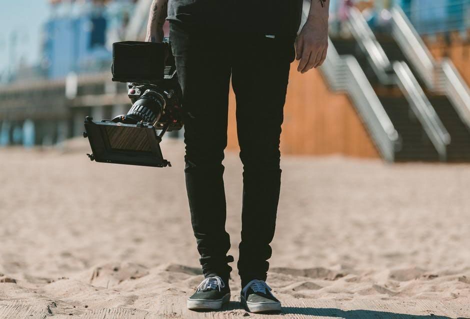 man walking with video camera