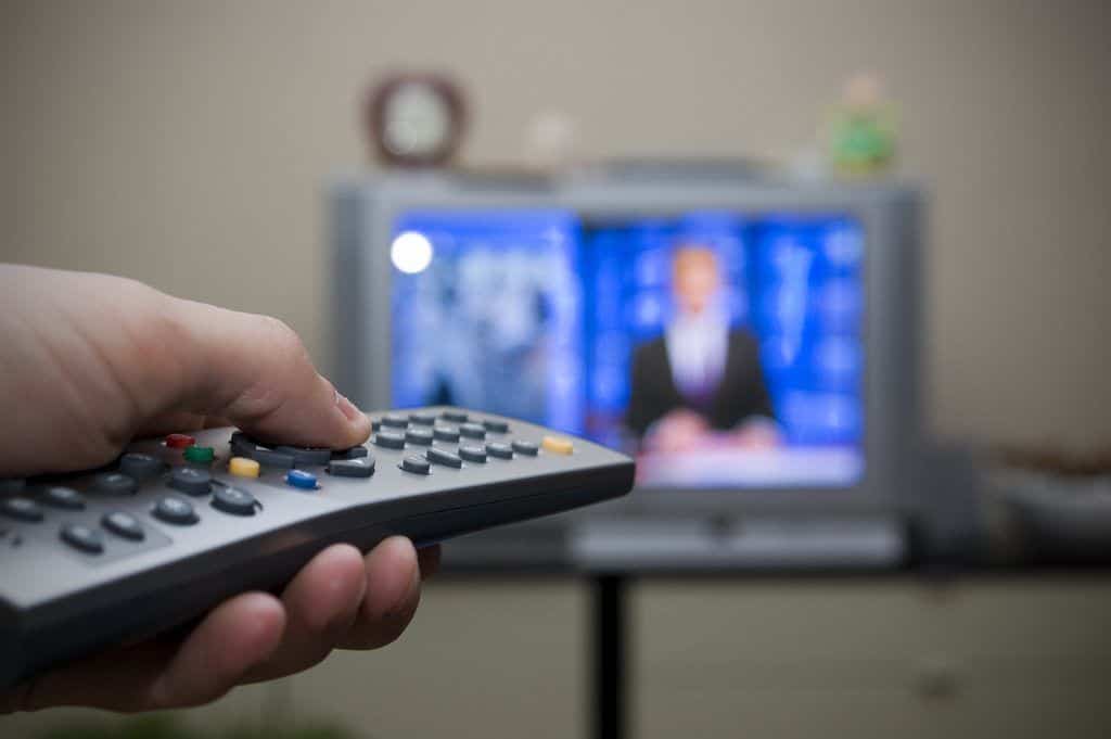 person using a TV remote