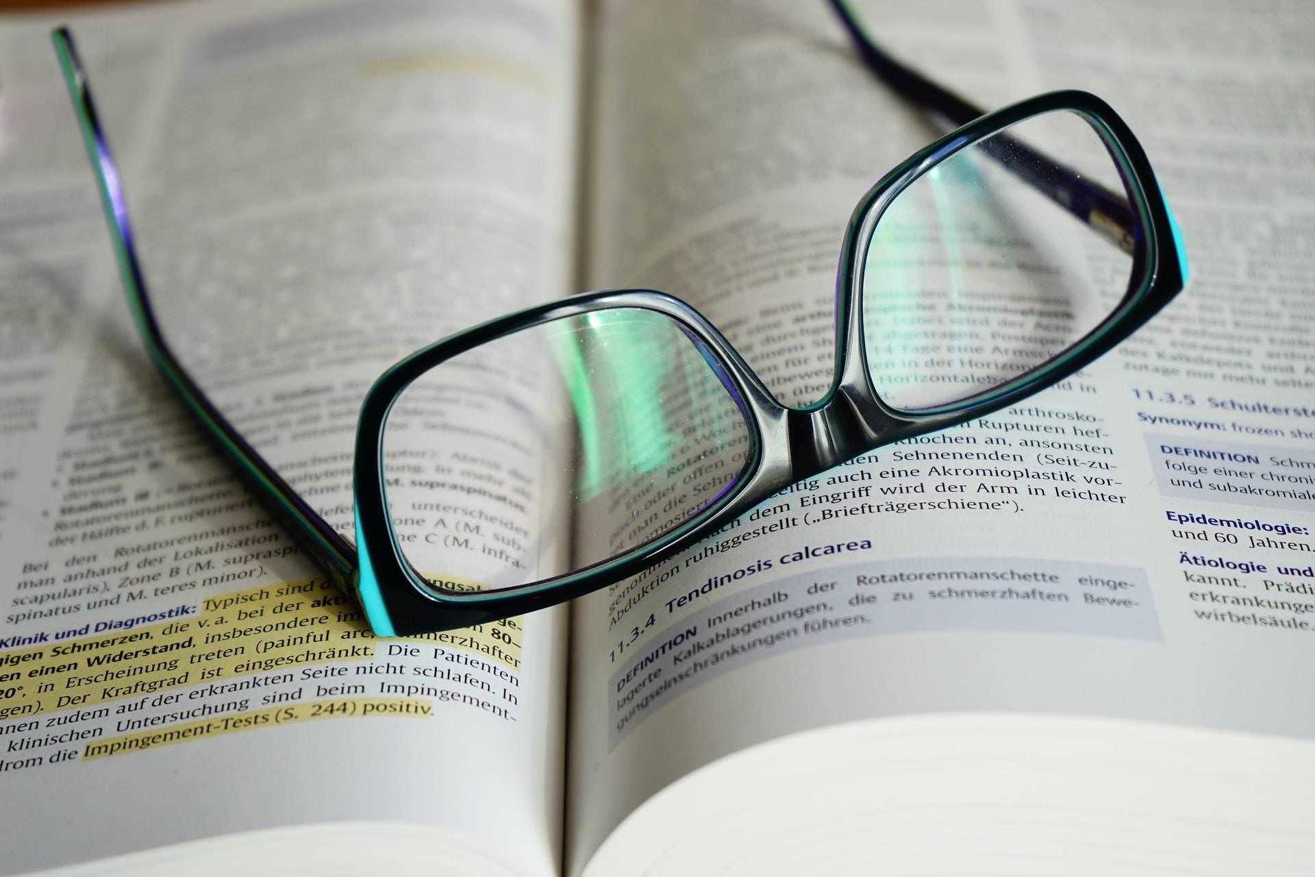 Eyeglasses on an open book