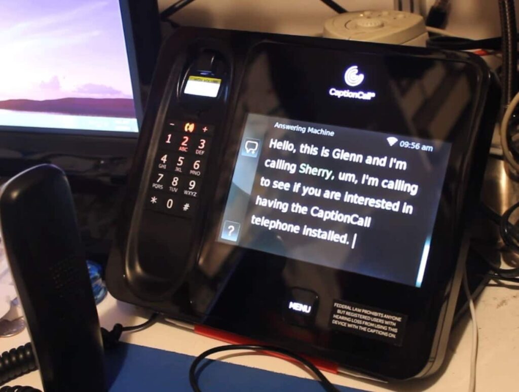 Close Up of a captioned telephone device, complete with captions on display