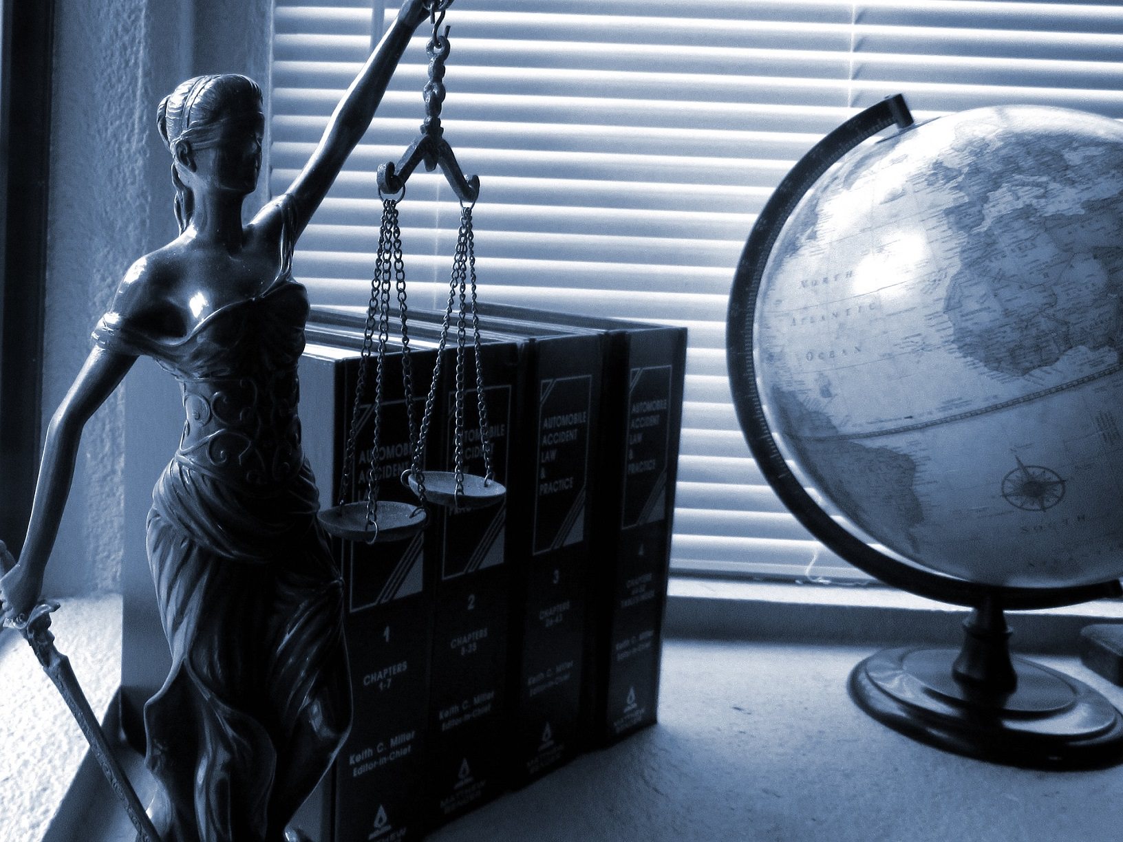 Lady Justice with Scales on a office desk