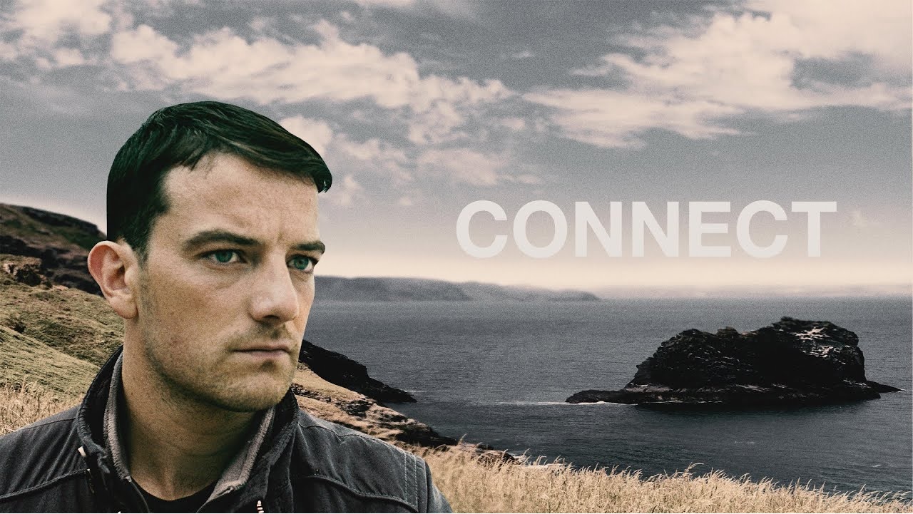 Image of man, seen from the shoulders up, in front of a grassy beach with the words and title of the movie - 'Connect' - on his left