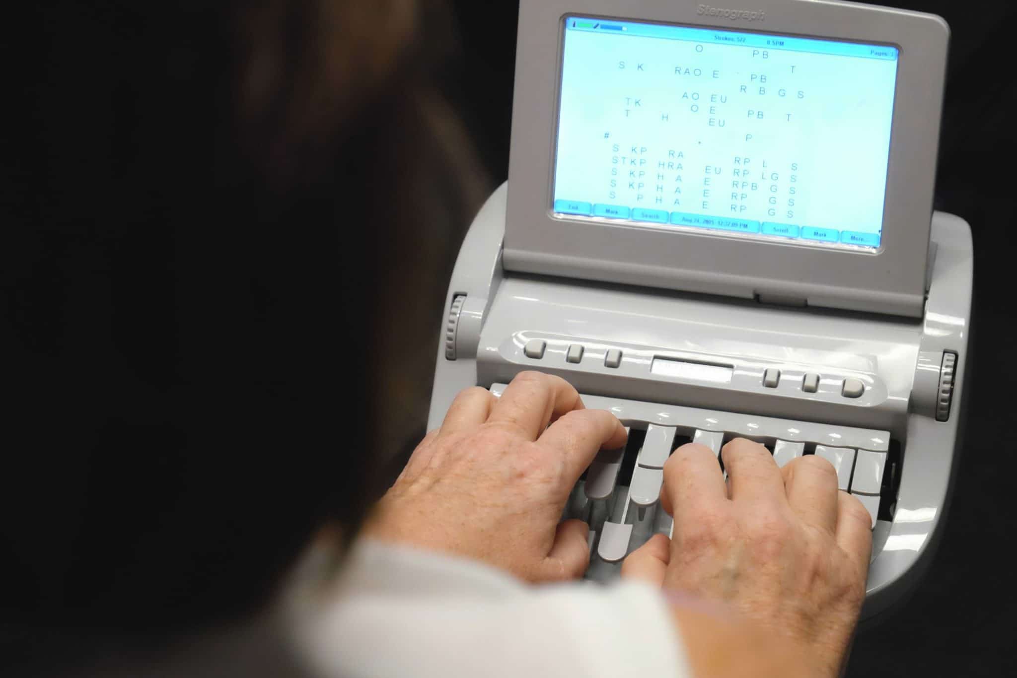 Woman using a steno machine for captioning