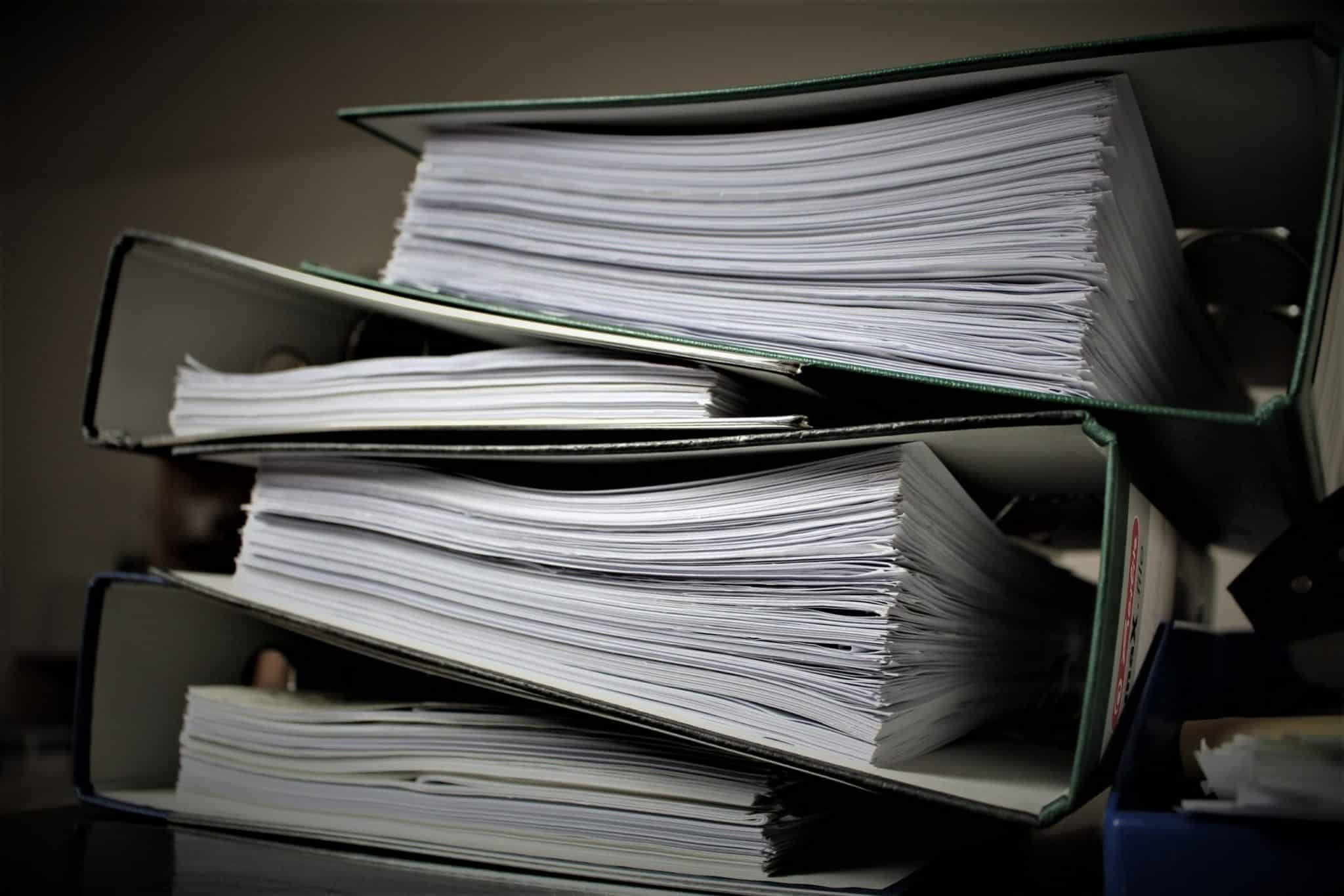 Court documents stuffed into three large binders