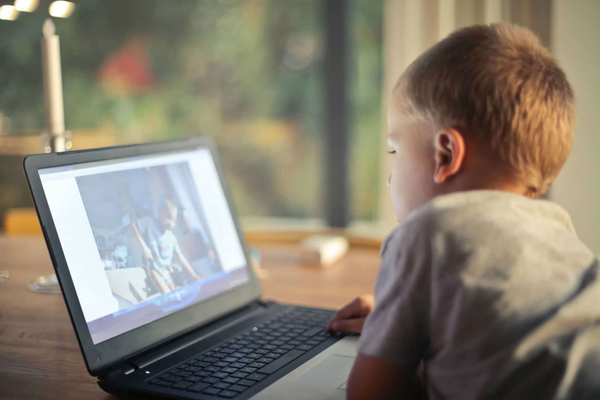 boy watching videos on a laptop