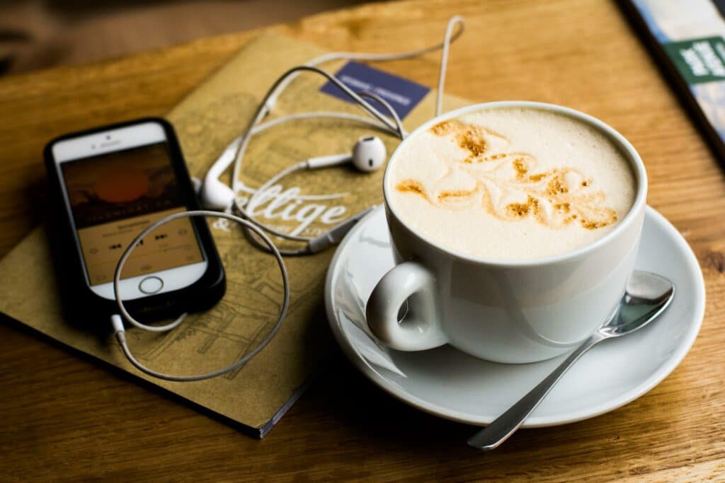 person listening to a podcast while having a cup of coffee for the ADA blog