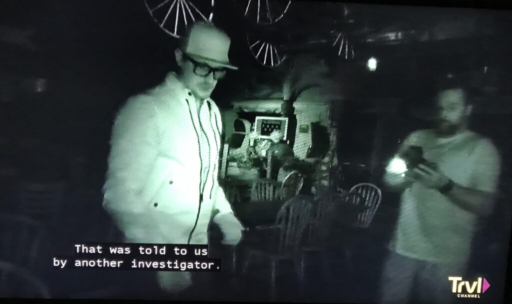 Ghost hunters in a darkened room with the captions reading 'that was told to us by another investigator.' For ghostly blog