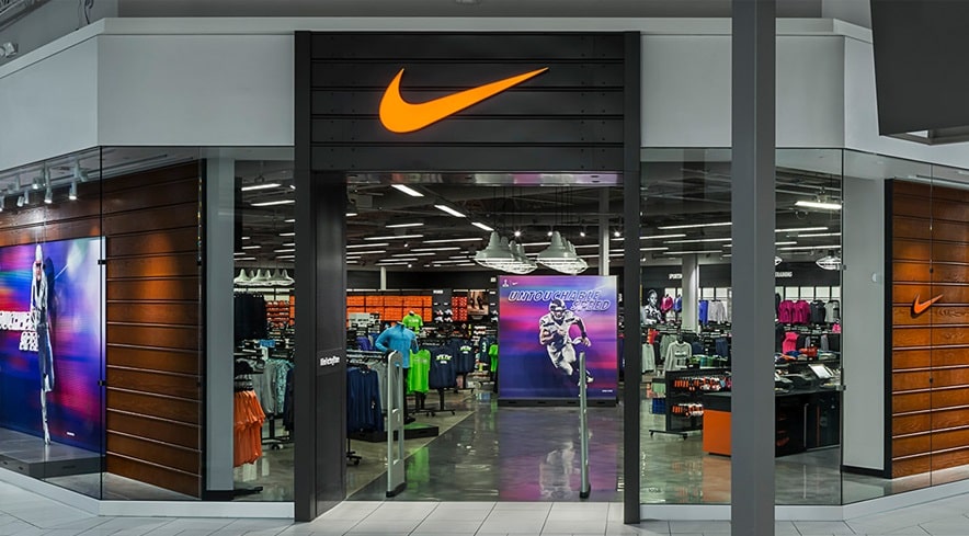 Exterior photo of a Nike store, with the Nike swoosh logo about the door