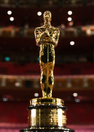 Academy Award statue in front of an empty theater
