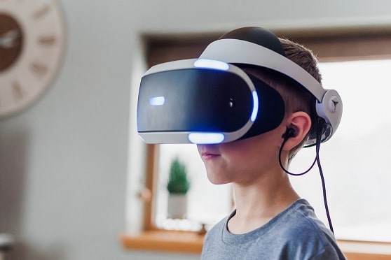Little boy wearing virtual reality goggles for XR Access blog