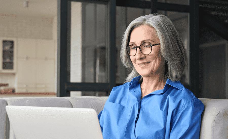 older woman looking at a laptop