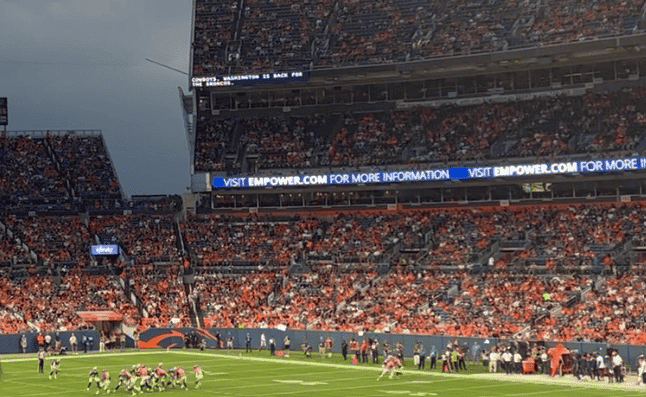 Denver Broncos at Empower Stadium playing a preseason game with in stadium captions playing on the stadium ribbon board