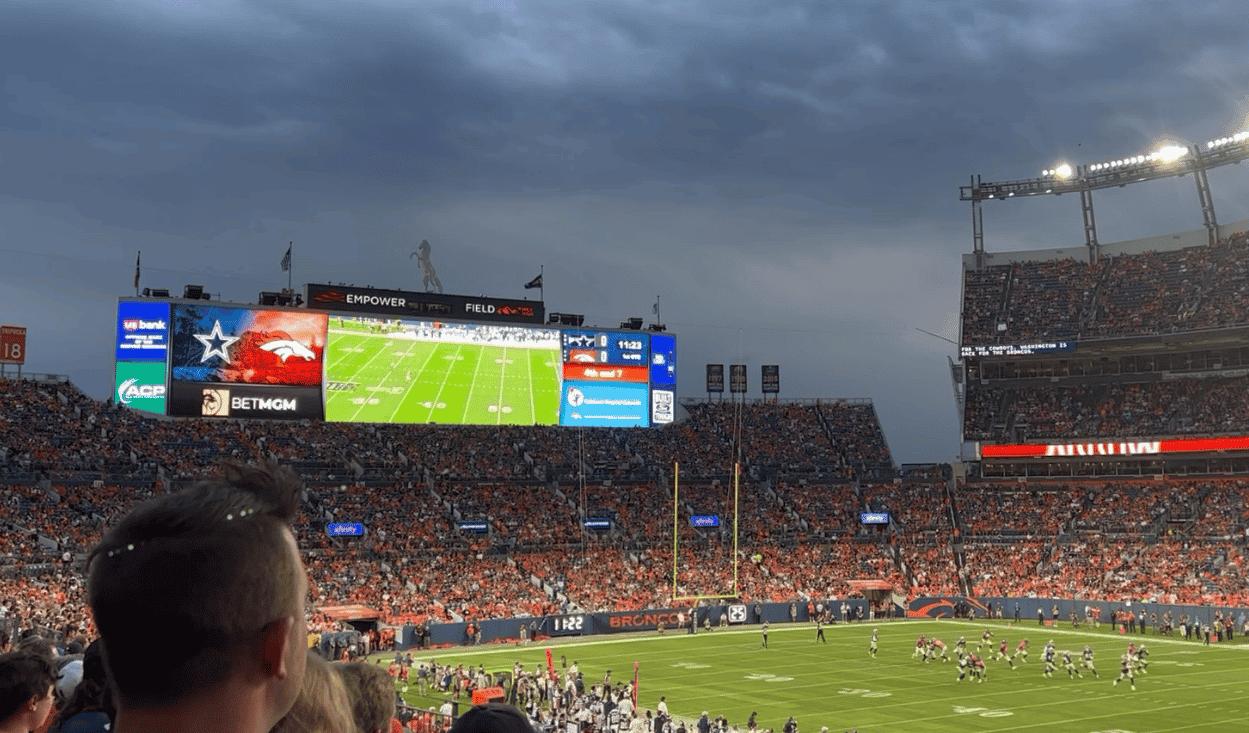 Fans in the stadium watch the Denver Broncos play a preseason football game