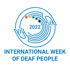 The logo for International Week of Deaf People. The logo features outline drawings of two hands in blue and white, with lines to help the hands form a large circle around five smaller semicircles inside. Each semicircle has a star at the base each in a different color, red, yellow, green, bright blue, and black. Inside also in blue is the year 2022.