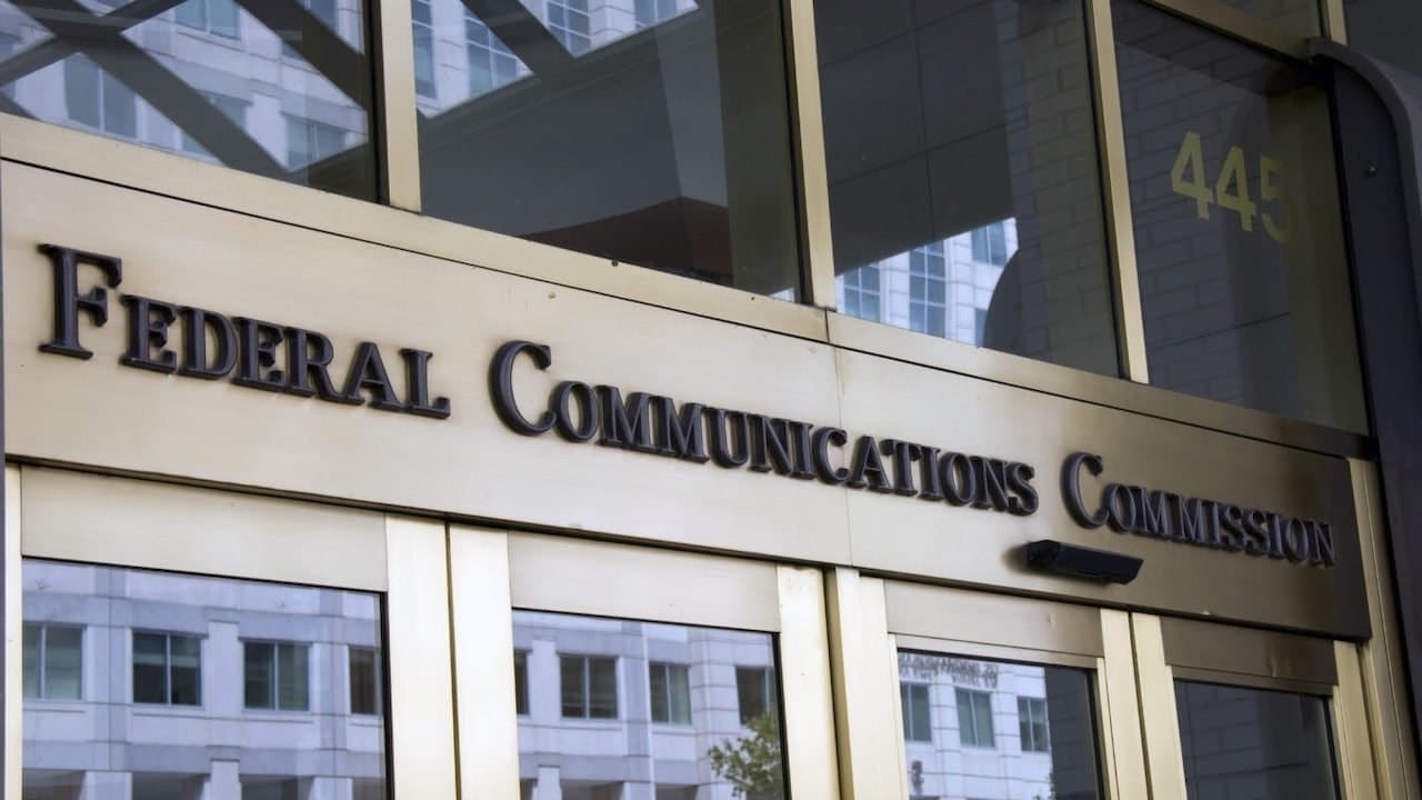 Exterior of the FCC building in Washington, DC, with the words Federal Communications Commission above the door for the audio description blog