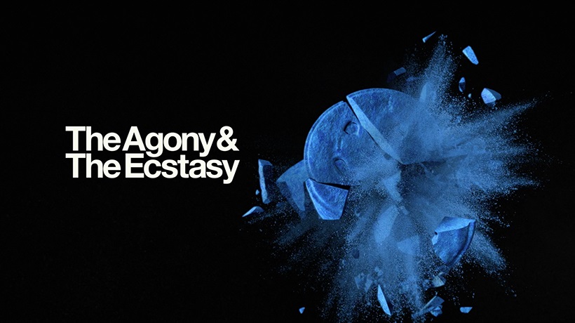 Title screen of 'The Agony and the Ecstasty' showing a blue pill being smashed into pieces