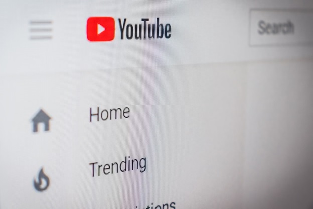 Closeup of YouTube's home page menu showing 'trending' tab and a 'home' tab