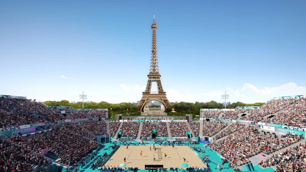 A volleyball court and filled spectator stands sit in front of the Eiffel Tower in Paris 